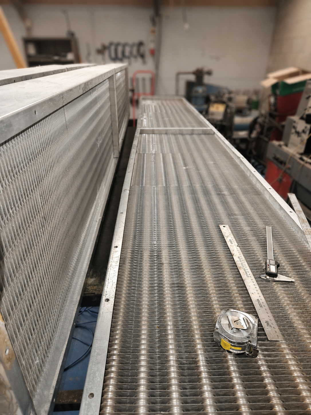 Large industrial heating coil standing in the GES workshop