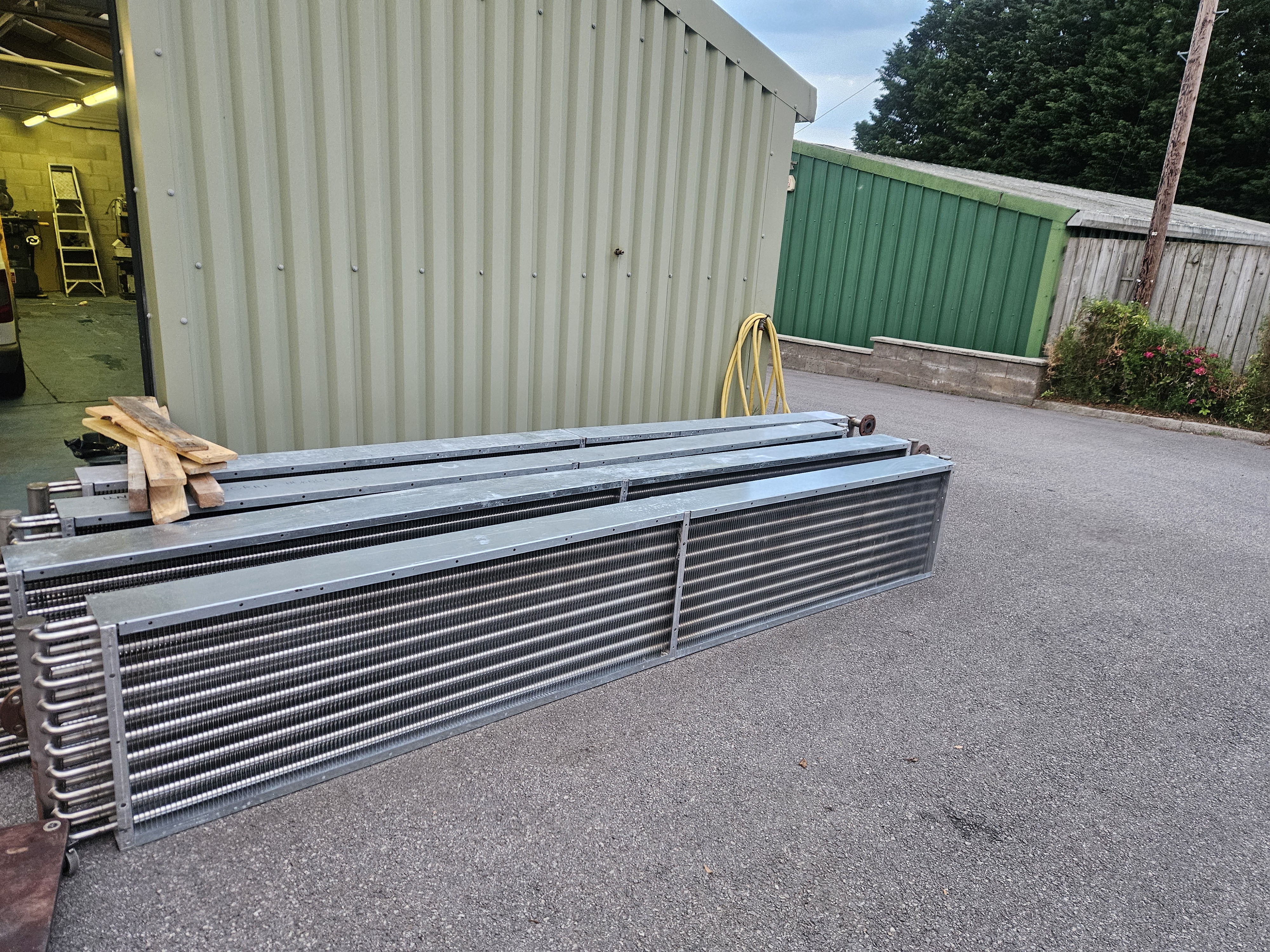 Multiple large industrial coils arranged in the GES workshop