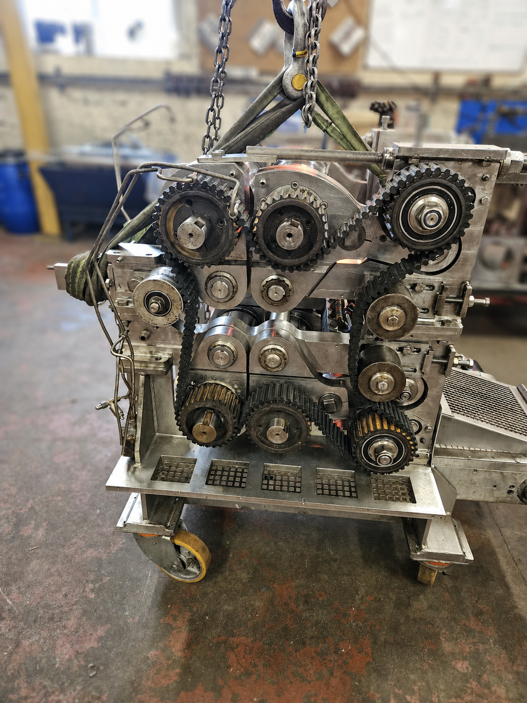 Substantial industrial drive assembly with exposed sprockets, rollers and lifting chains
